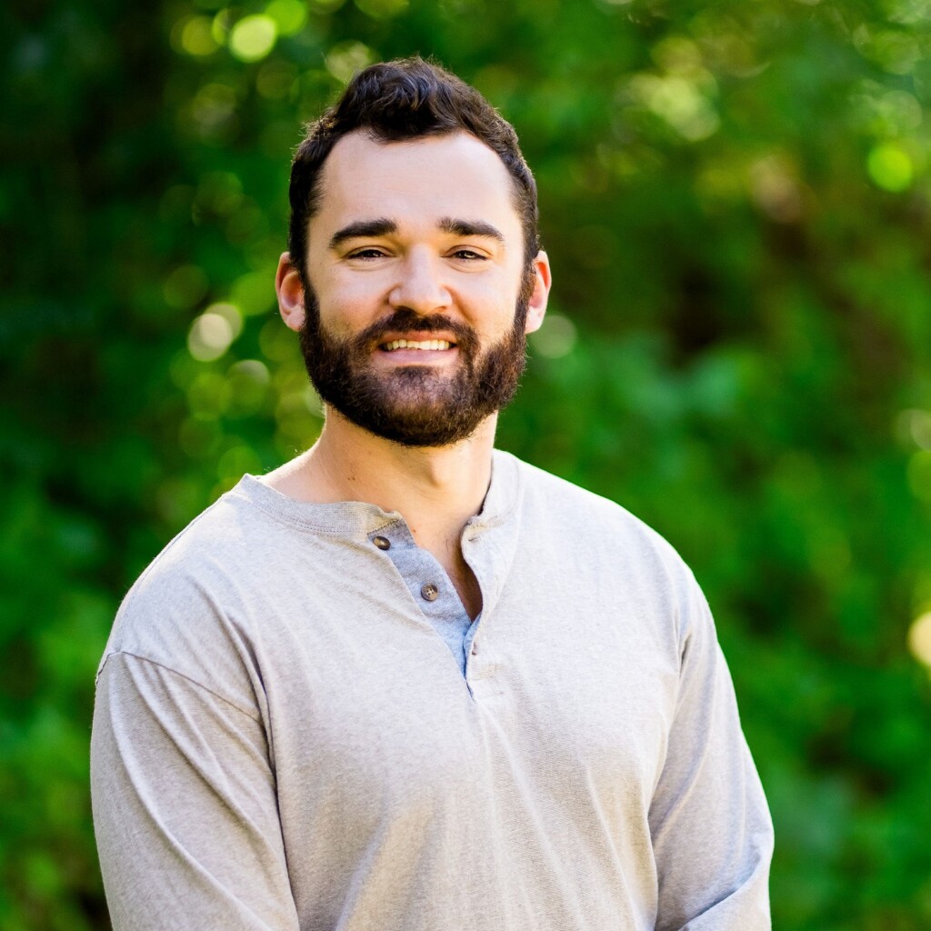 Aaron Kressig standing in front of a green background
