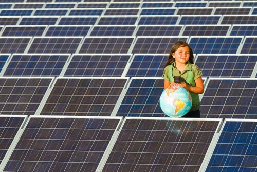 native girl standing in solar field with globe