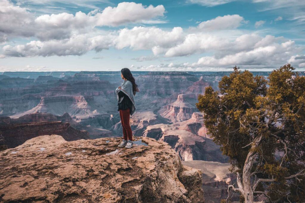 woman standing over grand canyon