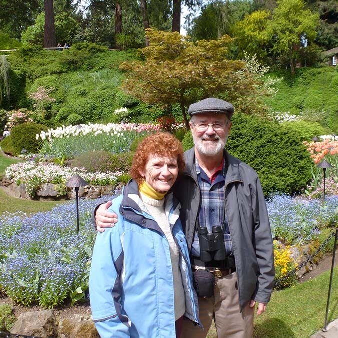 Anne and Bob Barry stand in front of Butchart Gardens ready to birdwatch.