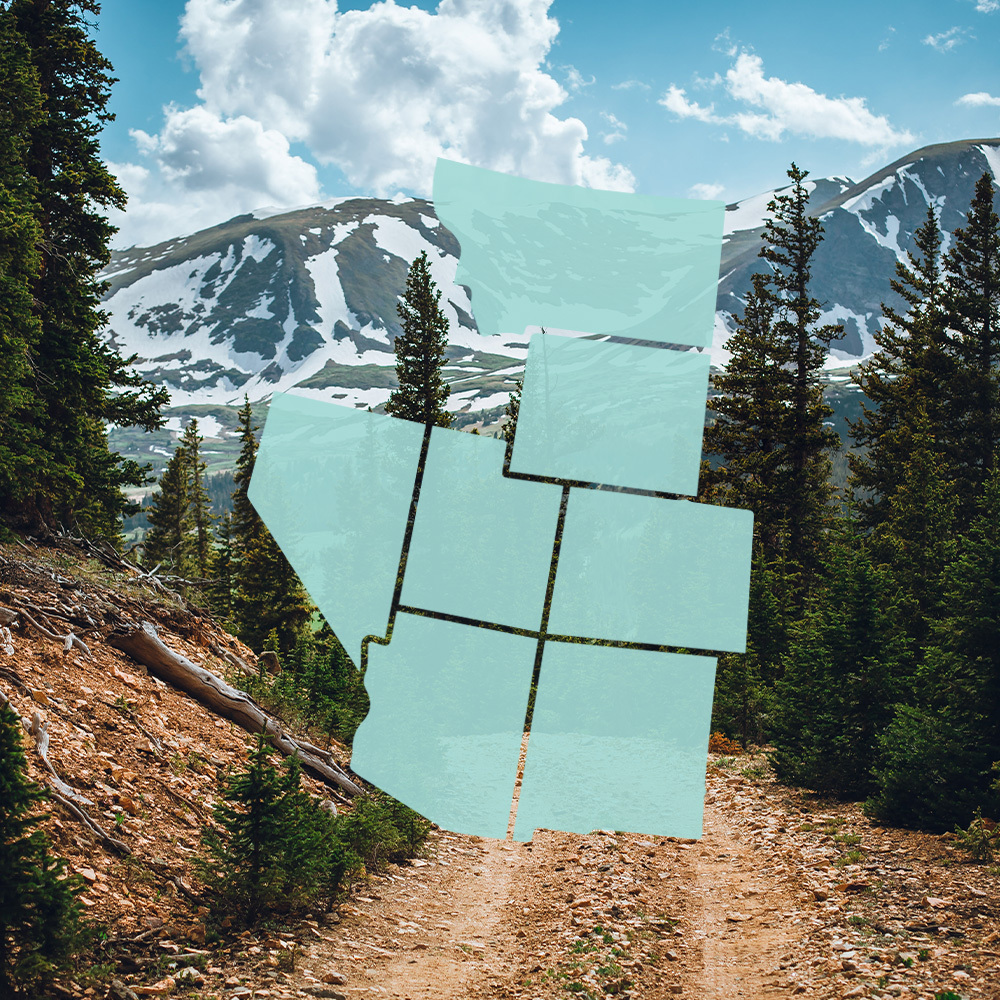 2023_0226_StateGraphic_1000x1000_v2 Map outline of western U.S. states overlaying a mountainous dirt path with trees, snow-capped peaks, and a cloudy sky in the background.