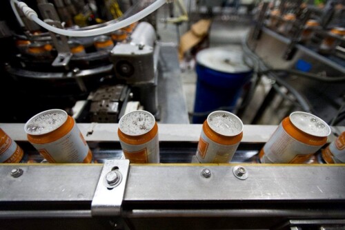 Aluminum cans on a canning line at Upslope Brewing being filled with beer.