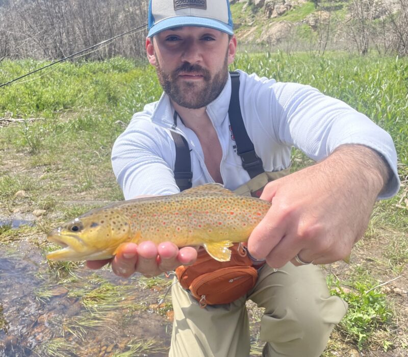 Aaron with his brown trout catch in Rocky Mountain National Park.