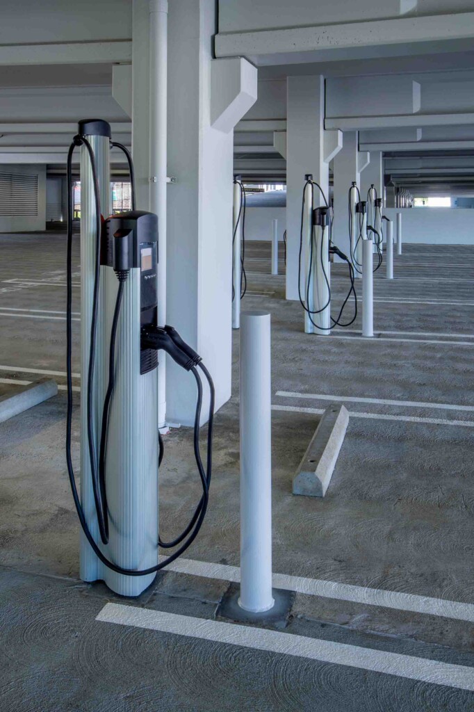 2024_0806_ChargingStation_iStock-1396354148 A row of electric vehicle charging stations in an empty parking garage.