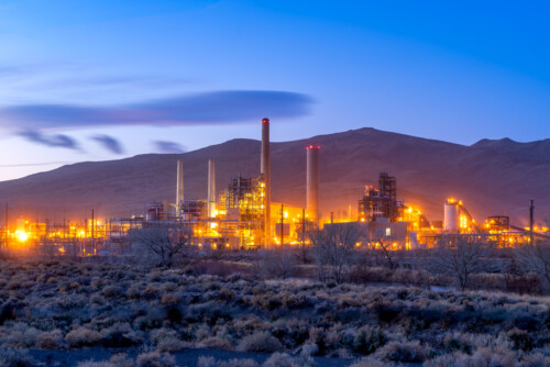 Power plant refinery with smoke stacks and chimneys near Reno Nevada at sunrise