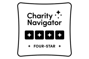 Charity Navigator four-star rating badge featuring four black stars and the text “Charity Navigator Four-Star” on a white background.