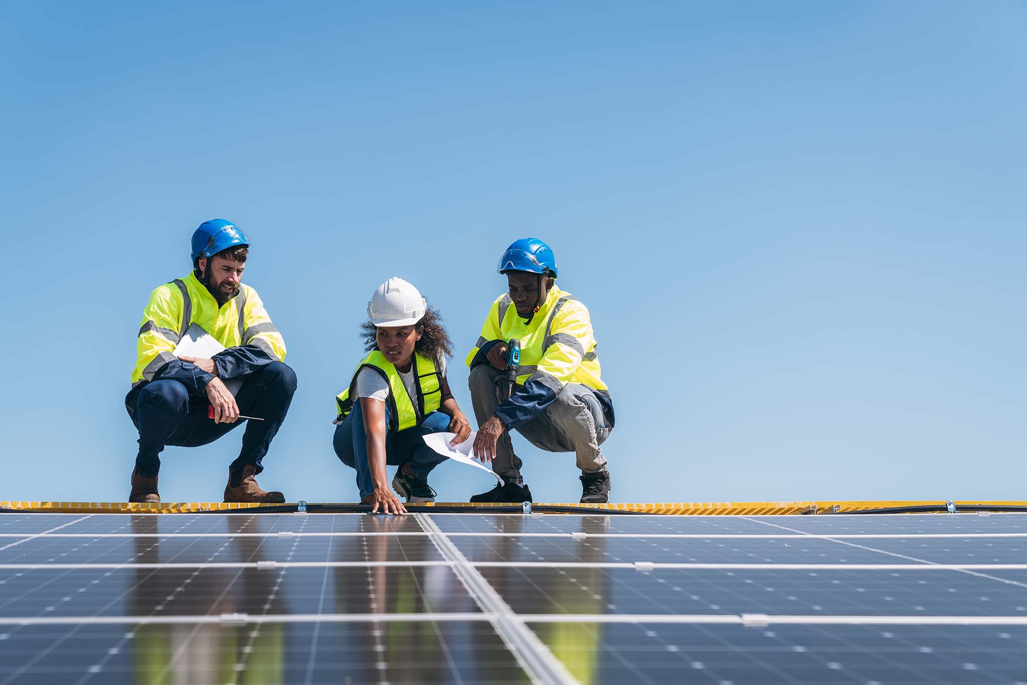 Service engineer checking solar cell on the roof for maintenance if there is a damaged part.